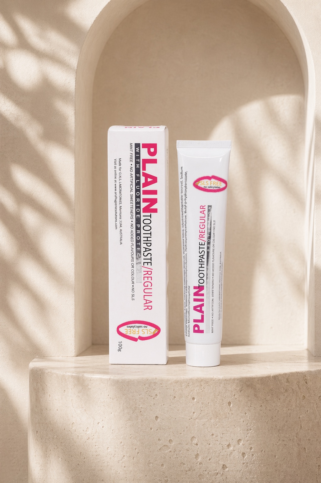 Plain Toothpaste on a curved plaster plinth with architectural arch shadow